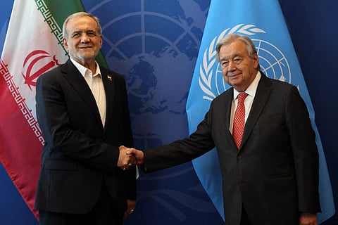 Iranian President Masoud Pezeshkian (L) shakes hands with the United Nations (UN) Secretary General Antonio Guterres during the UN's General Assembly on September 25, 2025, in New York City.