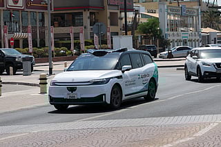 Robotaxi, a driverless autonomous vehicle, on a trial run with a safety driver at Jumeirah Beach Road, Dubai.