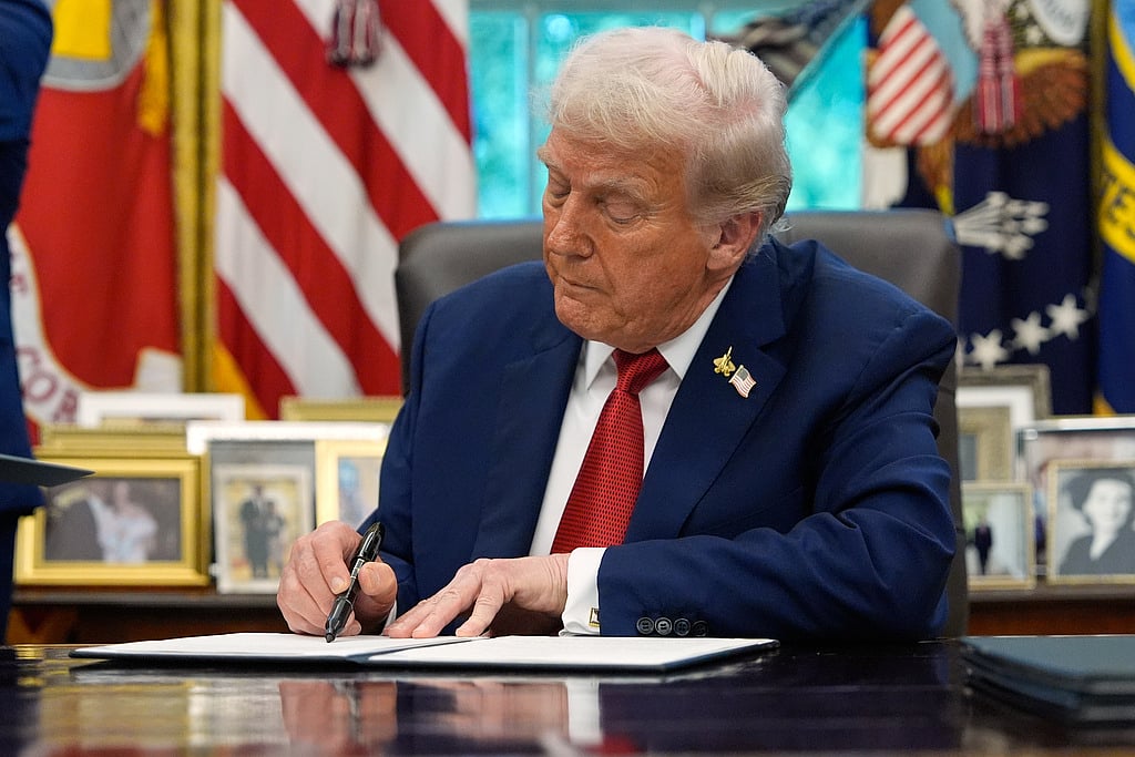 President Donald Trump signs a presidential memorandum on the death penalty in the District of Columbia in the Oval Office at the White House, Thursday, Sept. 25, 2025, in Washington.