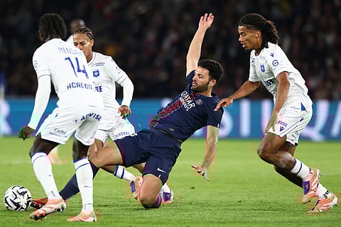 Paris Saint-Germain's Portuguese forward Goncalo Ramos (C) vies for the ball during the French L1 football match against Auxerre at the Parc des Princes stadium in Paris on September 27, 2025.