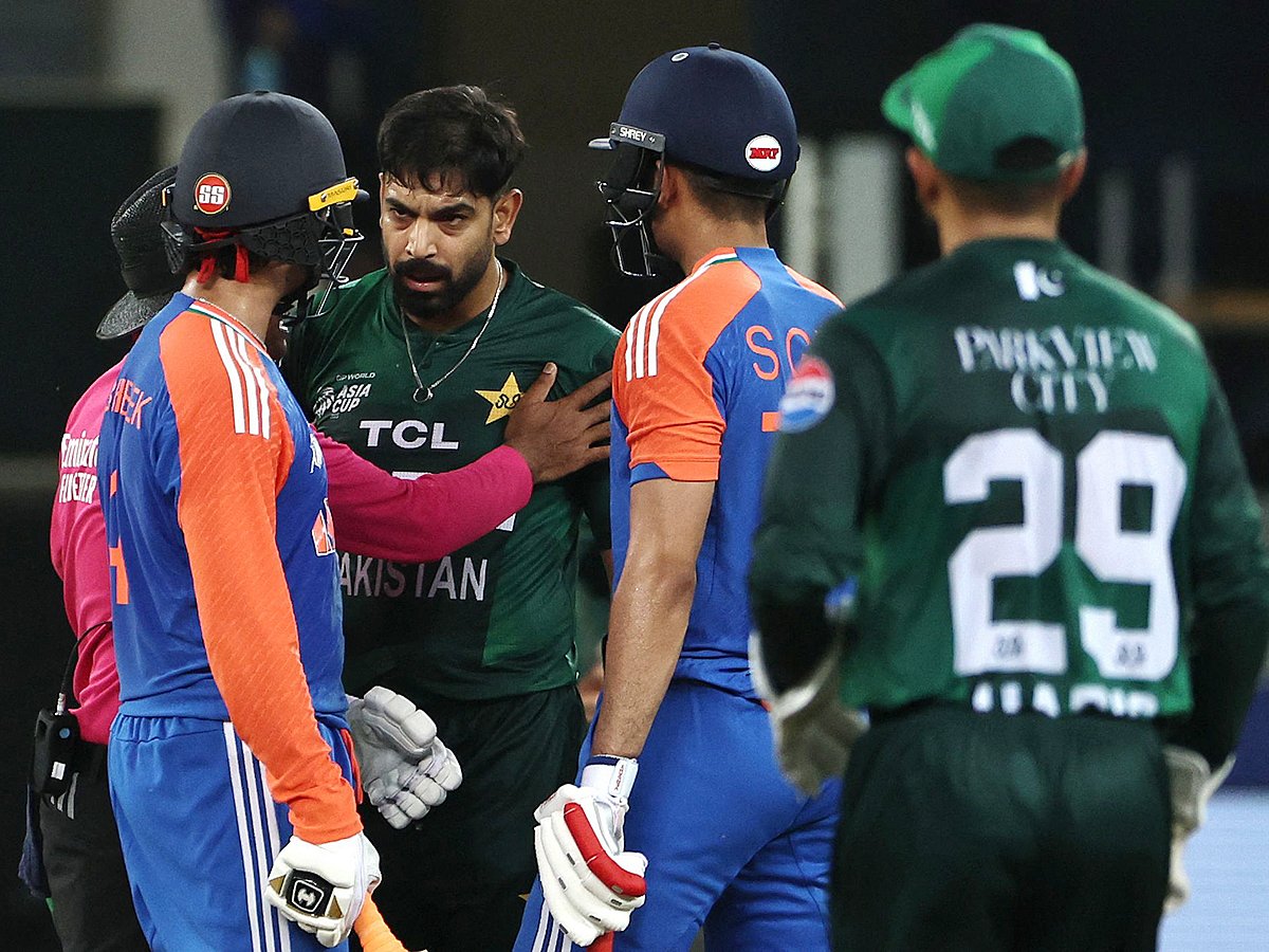Pakistan's Haris Rauf speaks with India's Abhishek Sharma as Shubman Gill watches during the Asia Cup 2025 Super Four T20I at the Dubai International Stadium on September 21, 2025. 