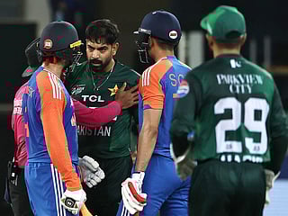 Pakistan's Haris Rauf speaks with India's Abhishek Sharma as Shubman Gill watches during the Asia Cup 2025 Super Four T20I at the Dubai International Stadium on September 21, 2025. 