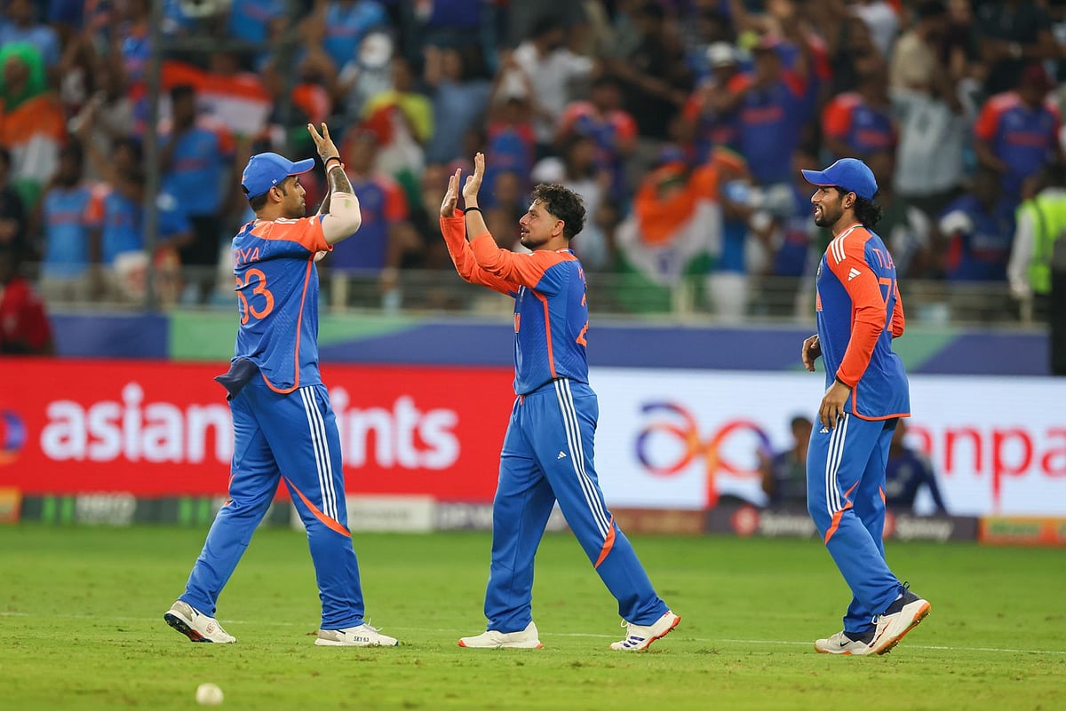 India's Kuldeep Yadav (centre) celebrates after taking the wicket of Pakistani batsman Faheem Ashraf. 