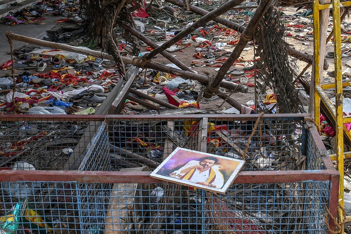 A portrait of actor-turned-politician Vijay is seen near the scattered shoes after a stampede that broke out Saturday evening during his political rally in the Karur district, in the Indian state of Tamil Nadu, on September 28, 2025.