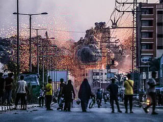 The Siena International Photo Awards 2025 crowned Palestinian photographer Ali Jadallah as the overall winner for his haunting image Leaving Home, taken in Gaza’s Deir al-Balah after an airstrike. The picture captures three people emerging from the rubble, symbolising both devastation and human resilience. 

