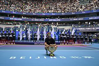 Italy’s Jannik Sinner poses with the trophy after winning the men’s singles final against USA’s Learner Tien at the China Open tennis tournament in Beijing on October 1, 2025.