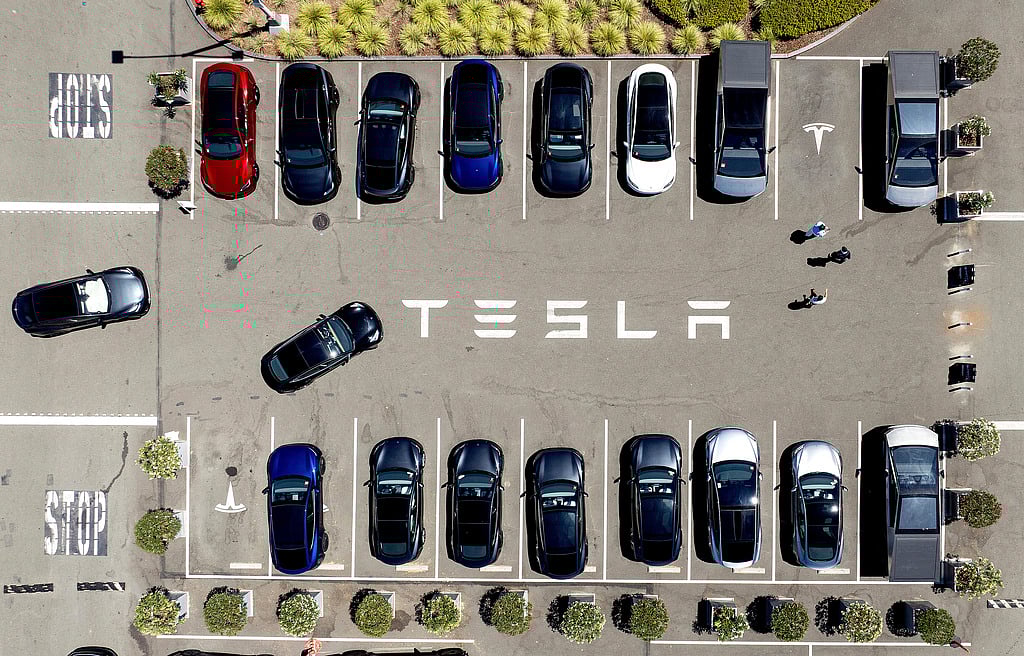 FILE - Tesla vehicles line a parking area at the company's Fremont, Calif., factory, Aug. 5, 2025. (AP Photo/Noah Berger)