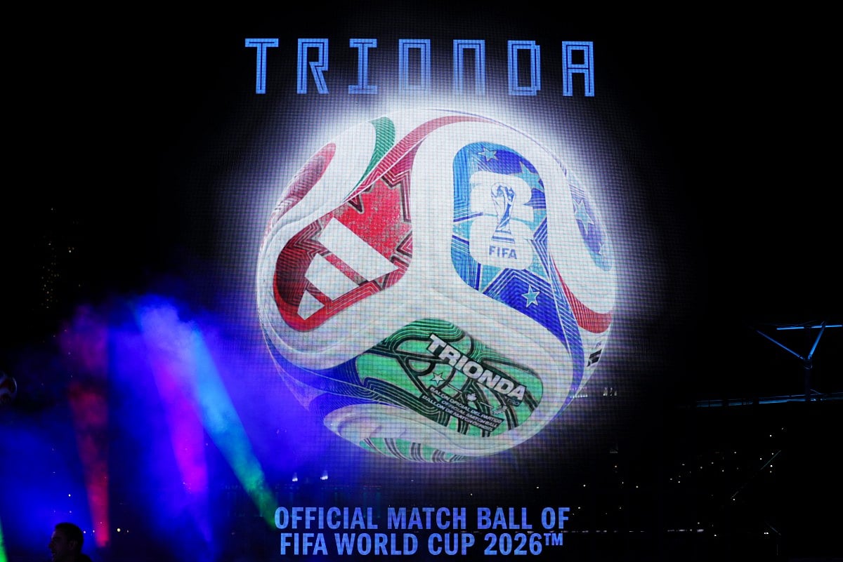 A large video screen shows the 2026 FIFA Men's World Cup match ball named Trionda during its unveiling in New York on October 2, 2025.