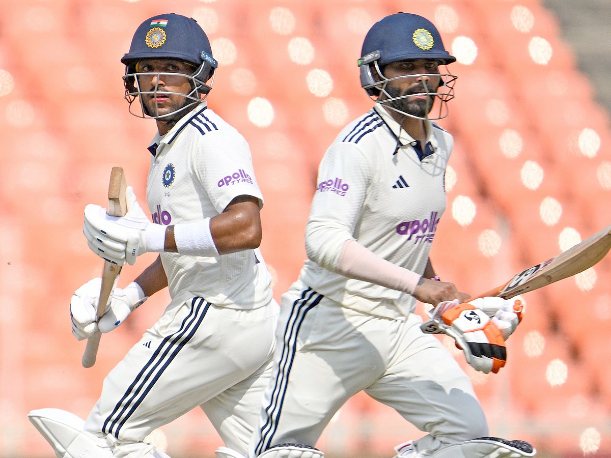 India's Ravindra Jadeja (R) and Dhruv Jurel run between wickets during the second day of the first Test match against West Indies at the Narendra Modi Stadium in Ahmedabad on October 3, 2025. 
