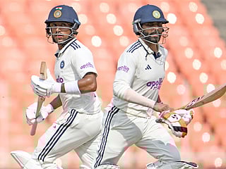 India's Ravindra Jadeja (R) and Dhruv Jurel run between wickets during the second day of the first Test match against West Indies at the Narendra Modi Stadium in Ahmedabad on October 3, 2025. 