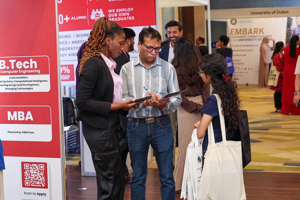 Families discussing education opportunities with exhibitors at Edufair 