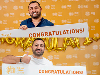 Anthony El Ghaoui while receiving his first prize (on top) and second prize (bottom) at The UAE Lottery studio. 