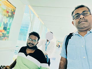 Sai Krishna V (left) was accompanied by community volunteer Praveen Kumar (right) on his flight home.