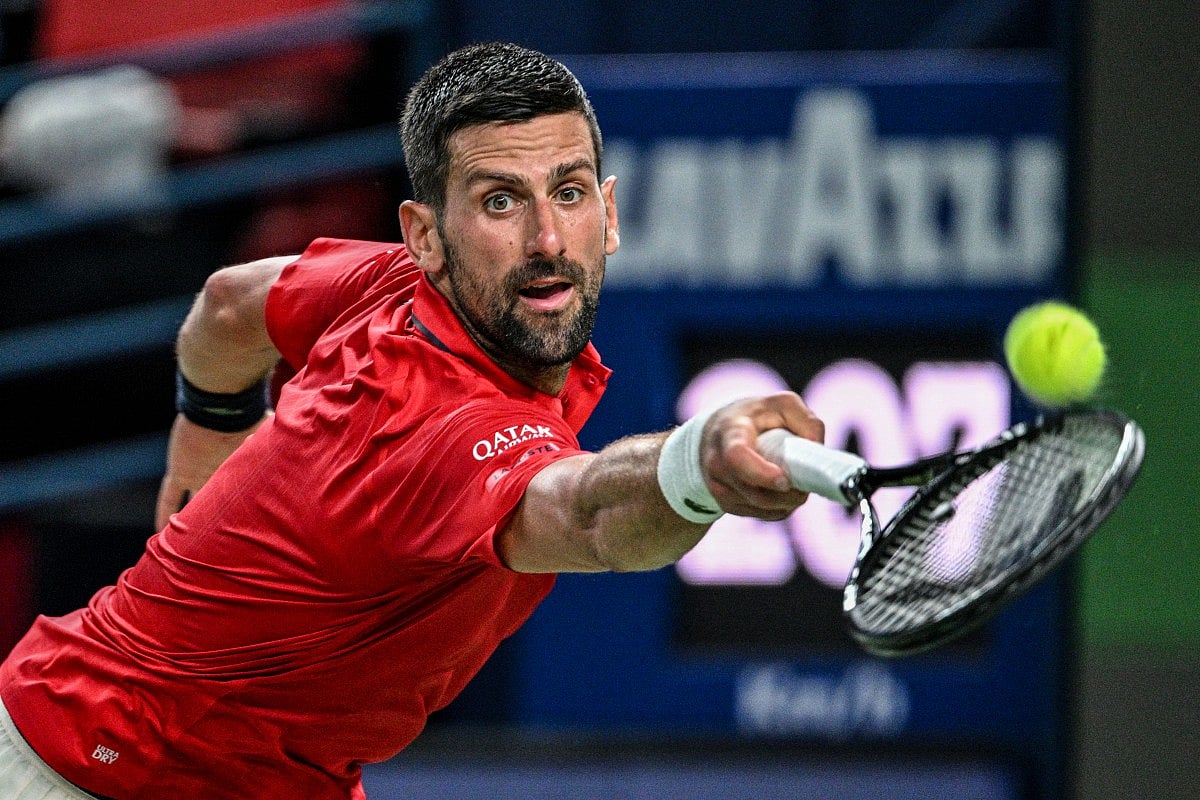 Serbia's Novak Djokovic hits a return to Germany's Yannick Hanfmann during their men's singles match at the Shanghai Masters tennis tournament in Shanghai on October 5, 2025.