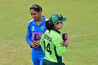 India's captain Harmanpreet Kaur and her Pakistani counterpart Fatima Sana walk past after the toss ahead of the ICC Women's Cricket World Cup 2025 one-day international (ODI) match at the R. Premadasa International Cricket Stadium in Colombo on October 5, 2025.