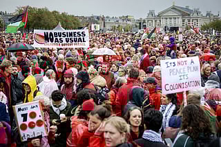 Demonstrators gather at Museumplein for a "Red Line" protest demanding "government action to stop the genocide in Gaza" with the The Concertgebouw concert hall in the background in Amsterdam on October 5, 2025.