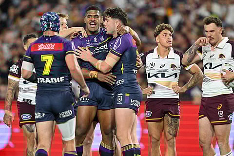 Melbourne Storm's Alec MacDonald (2nd L) and Trent Loiero (C) celebrate after scoring a try during the National Rugby League (NRL) Grand Final match between the Melbourne Storm and Brisbane Broncos at Accor Stadium in Sydney on October 5, 2025.