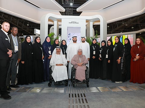 Director General of Dubai Municipality Marwan Bin Ghalita (centre), poses for a group photo at the civic body's stand at AccessAbilities Expo 2025 on Monday. 