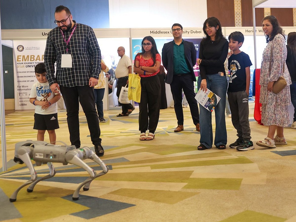 Parents and children explore the future of robotics  at Gulf News Edufair Dubai 2025.