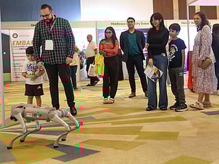 Parents and children explore the future of robotics  at Gulf News Edufair Dubai 2025.