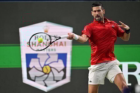 Serbia's Novak Djokovic hits a return to Spain's Jaume Munar during their men's singles match at the Shanghai Masters tennis tournament in Shanghai on October 7, 2025.