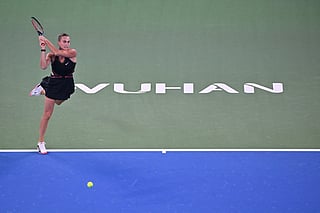 Belarus’ Aryna Sabalenka hits a return to Russia’s Liudmila Samsonova during their women’s singles match at the Wuhan Open tennis tournament in Wuhan, Central China’s Hubei province on October 9, 2025.