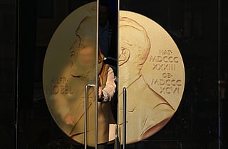 A person opens the door to leave the Swedish Academy ahead of the 2025 Nobel Prize in Literature at the Swedish Academy in Stockholm, Sweden, on October 9, 2025.
