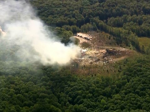 Smoke fills the air as debris covers the ground and vehicles after a powerful blast ripped through a military explosives manufacturing plant in Hickman County, Tennessee, on Friday, October 10, 2025.   