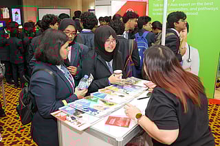 Students from schools in Abu Dhabi are interacting with university representatives at Gulf News Edufair 