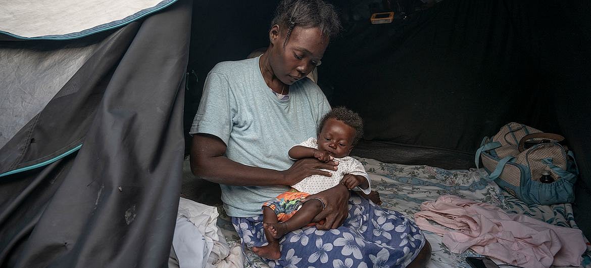 Many people in Haiti displaced by violence, like this mother and baby, struggle to find enough to eat.