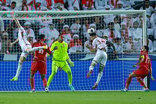 UAE's defender Marcus Meloni heads the ball to score his team's first goal past Oman's goalkeeper Ibrahim Al Mukhaini during the Fifa World Cup 2026 Asian qualifier football match at Jassim Bin Hamad Stadium in Doha on October 11, 2025.