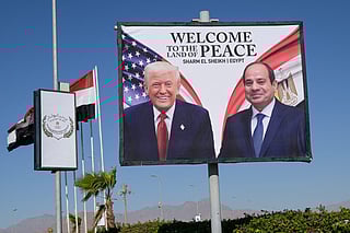 This photograph shows a billboard bearing the portraits of US President Donald Trump and Egyptian President Abdel Fattah Al Sisi outside the convention centre ahead of the Sharm Al Sheikh Peace Summit in the Egyptian Red Sea resort town of Sharm Al Sheikh on October 13, 2025.