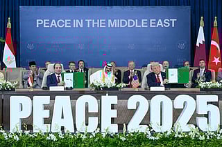 Trump (right) and Egypt's President Abdul Fattah Al Sissi show signed documents during a summit on Gaza in Sharm Al Sheikh on October 13, 2025.