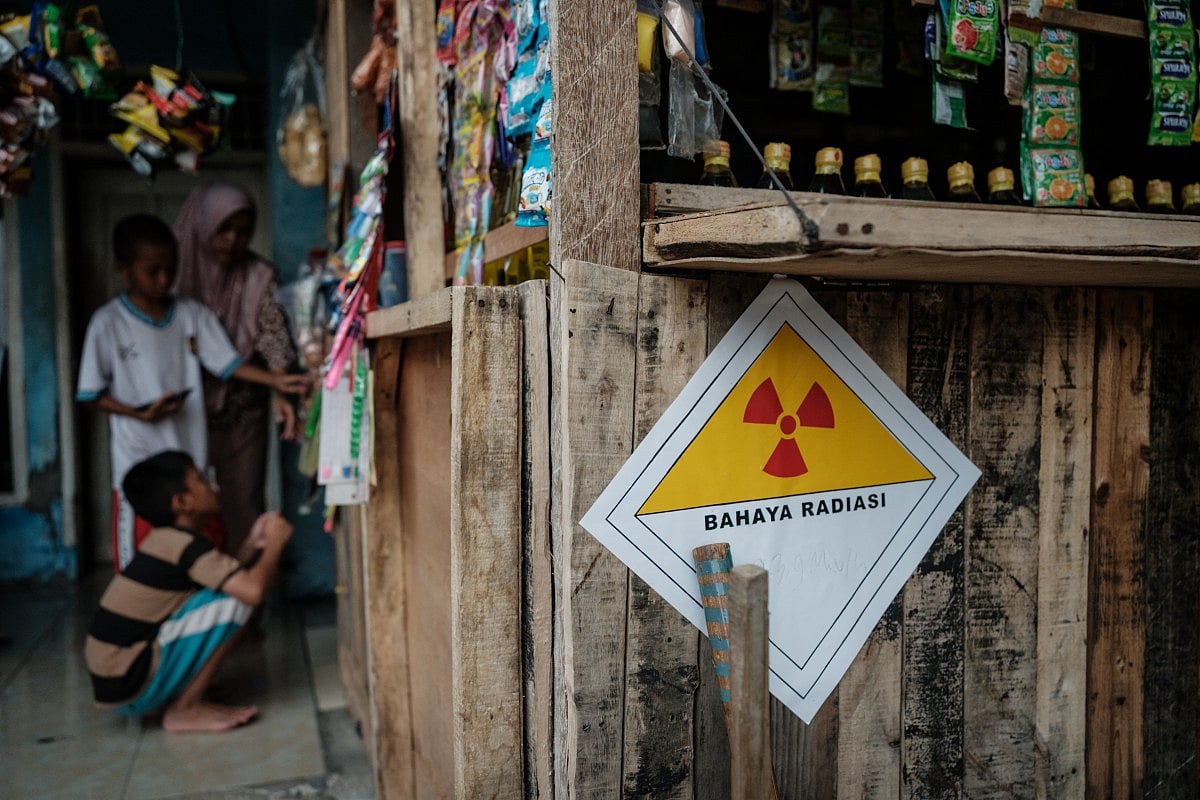 A warning sticker labelled “Danger Radiation” with a handwritten note showing “23.9 microsieverts per hour” is seen on the wall of a kiosk in front of a house next to the Modern Cikande Industrial Estate, where the radioactive isotope Caesium 137 was detected, in Sukatani, Banten province on October 13, 2025.