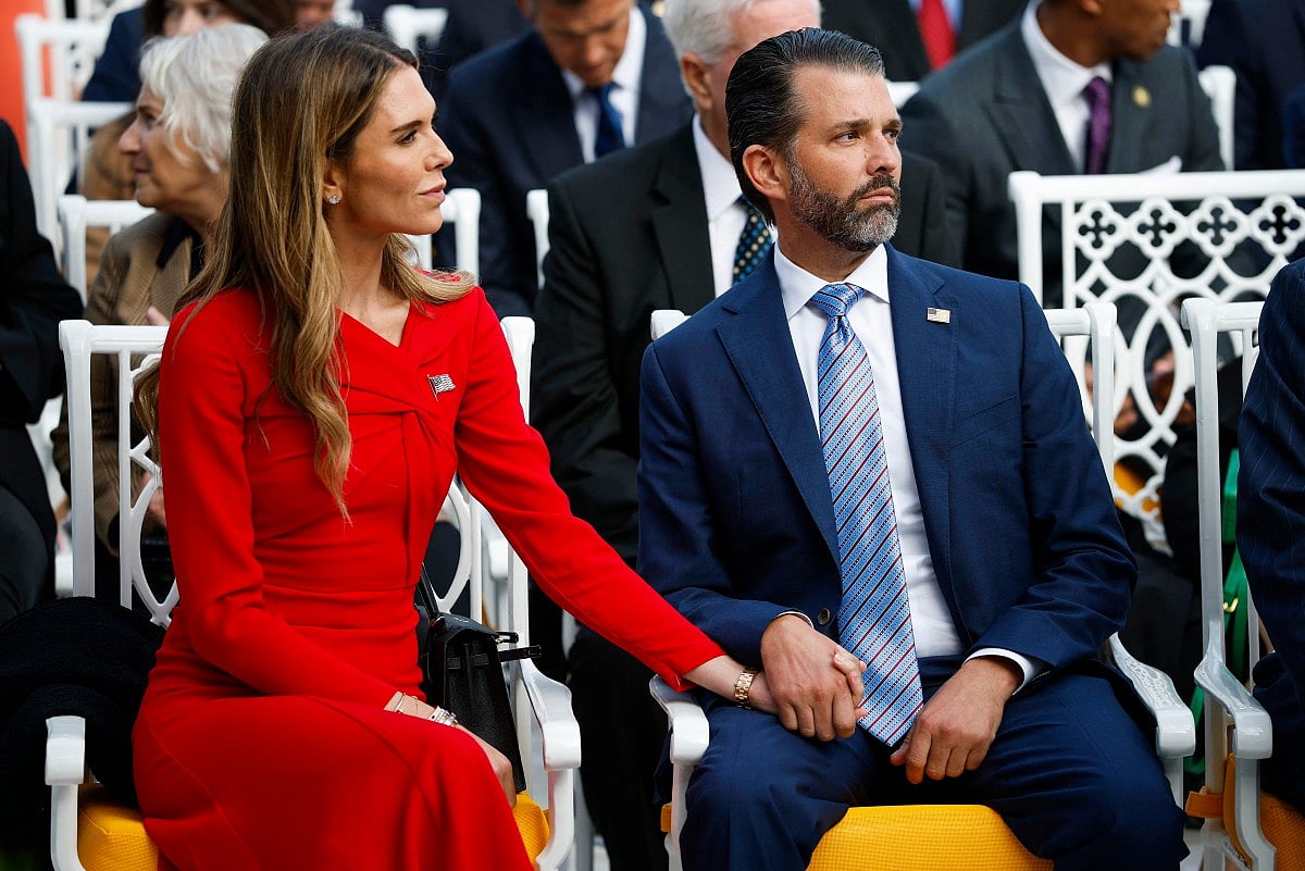Donald Trump Jr. (R) sits with his now-fiancé Bettina Anderson