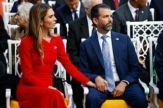 Donald Trump Jr. (R) sits with his now-fiancé Bettina Anderson 