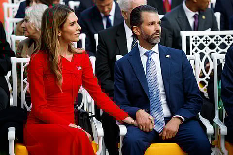 Donald Trump Jr. (R) sits with his now-fiancé Bettina Anderson 