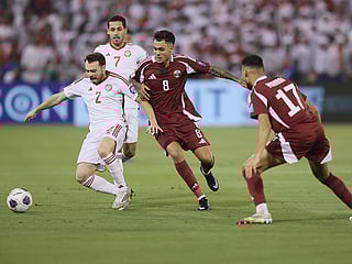 United Arab Emirate's Rúben Filipe, left, and Qatar's Edmilson Junior, center, fight for the ball during the 2026 World Cup qualifying soccer match between Qatar and United Arab Emirates at the Hamad Bin Jassim Stadium in Doha.