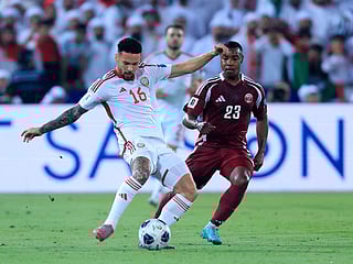 UAE's defender #16 Marcus Meloni is marked by Qatar's defender #23 Assim Madibo during the FIFA World Cup 2026 Asian qualifier football match between Qatar and the UAE at Jassim Bin Hamad Stadium in Doha.