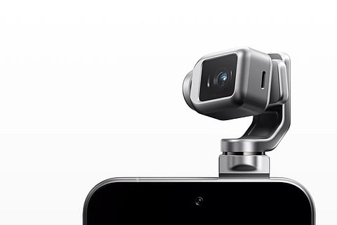 The short teaser video shows what appears to be a smartphone sprouting a tiny robotic arm with a camera mounted at the tip.