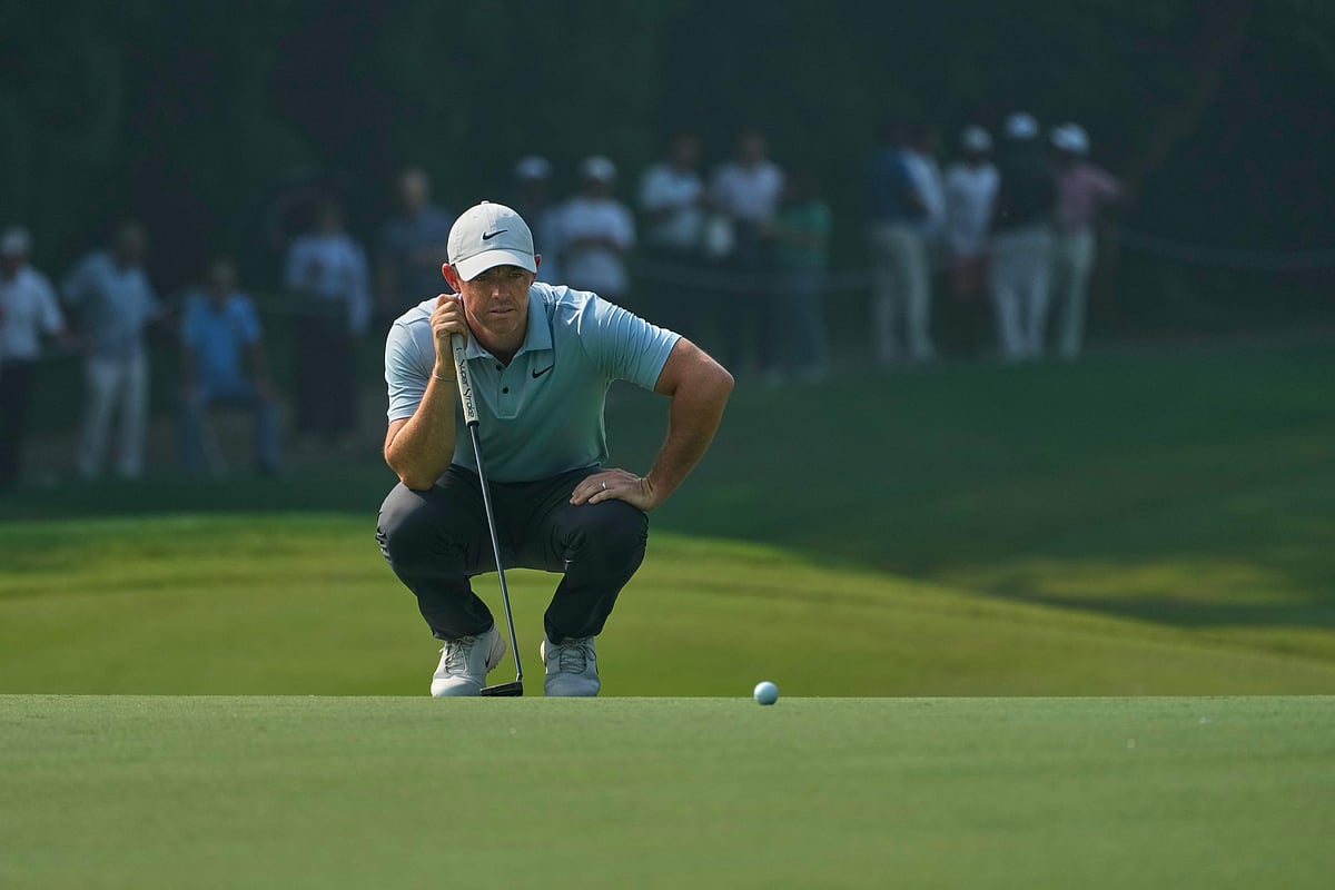 Rory McIlroy of Northern Ireland checks before taking a shot during the DP World Tour Championship golf tournament in New Delhi, India, Thursday, Oct. 16, 2025..