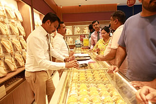 Shoppers compare intricate gold designs.