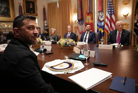 Ukrainian President Volodymyr Zelensky (L) looks on during a meeting with U.S. President Donald Trump and members of his Cabinet at the White House on October 17, 2025, in Washington, DC. 