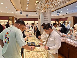Customers browse glittering gold bangles and necklaces at Dubai’s jewellery markets.