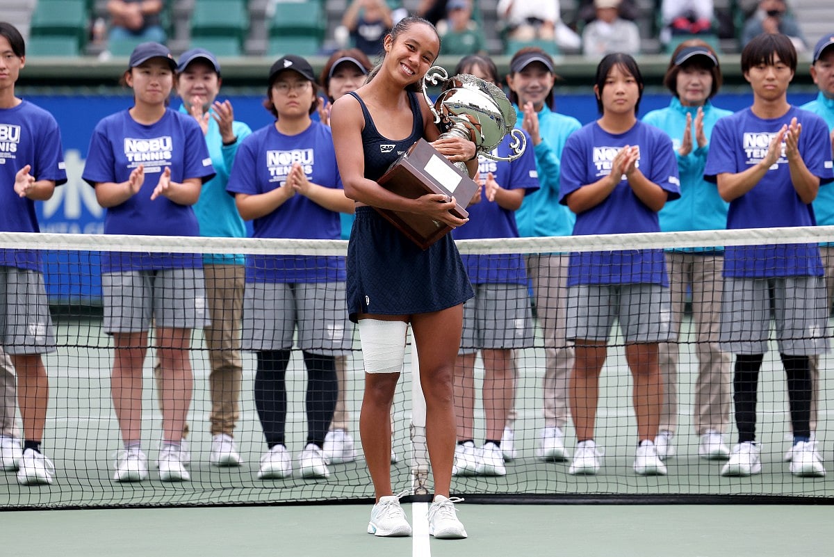 Canada's Leylah Fernandez poses with the winner's trophy after defeating Czech Republic's Tereza Valentova in their women's singles final match at the Japan Open tennis tournament in Osaka on October 19, 2025.