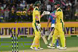Australia's Matt Renshaw (L) and Mitchell Marsh exchange bump gloves during the first one-day international cricket match between Australia and India in Perth on October 19, 2025.