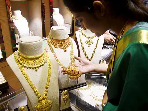 A woman shops for Gold jewellery on the occasion of Dhanteras festival.