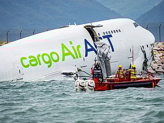 Rescue workers at the wreckage of an AirACT cargo aircraft operated for Emirates Airline near the runway at Hong Kong International Airport in Hong Kong, China, on Monday, October 20, 2025. 