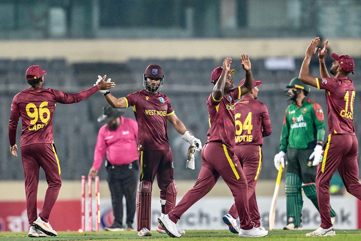 West Indies' players celebrate after winning the Super Over at the end of the second one-day international (ODI) cricket match against Bangladesh at the Sher-e-Bangla National Cricket Stadium in Dhaka on October 21, 2025.