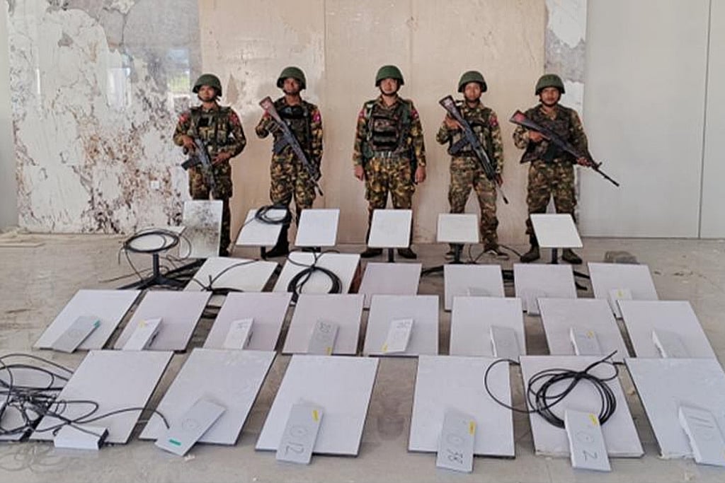 In this image provided by the Myanmar military on Oct. 19, 2025, soldiers stand next to Starlink machines as they seize KK Park online scam center in Myawaddy township, Karen State, Myanmar.